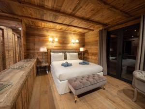 a bedroom with a bed in a room with wooden walls at Chalet K2 in Isola