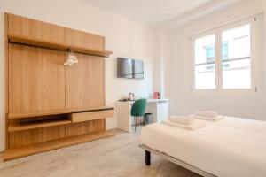 a white bedroom with a bed and a desk at Italianflat - Vandom 1 Suite Duomo Foresteria Lombarda in Milan