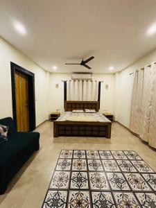 a bedroom with a bed and a couch in a room at Courtyard Villa in Bhopal +10 photos