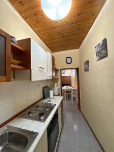 a kitchen with a sink and a stove top oven at casa cosetta in Gambassi Terme