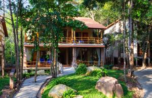 a house with a wrap around porch and trees at Valley Village Resort Phu Quoc in Phú Quốc