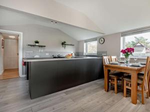 a kitchen and dining room with a table and a counter at 2 Bed in Ringwood oc-94272 in Saint Leonards