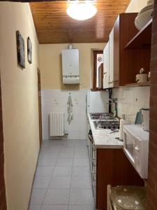 a kitchen with a sink and a stove at casa cosetta in Gambassi Terme +10 photos