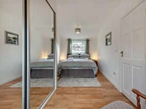 a bedroom with two beds and a mirror at 2 Bed in Ringwood oc-94272 in Saint Leonards