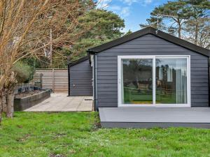 a black house with a window in a yard at 2 Bed in Ringwood oc-94272 in Saint Leonards +12 photos