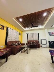 a living room with two couches and a table at Courtyard Villa in Bhopal