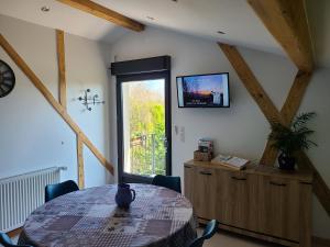a dining room with a table and a window at - - - - -Les Colombages - - - - Chambre d'hôtes-Gîte- Classement Gîte 3 étoiles in Mirepoix