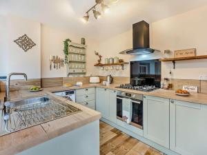 a large kitchen with white cabinets and a sink at 3 Bed in Freshwater oc-92961 in Freshwater