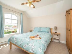 a bedroom with a bed with a tray of food on it at 3 Bed in Freshwater oc-92961 in Freshwater