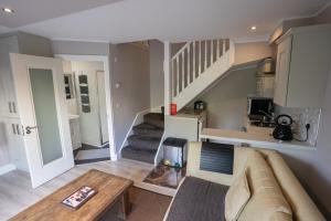 a living room with a couch and a staircase at Alensgrove Maisonette B in Leixlip