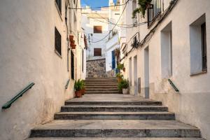 an alley with stairs in an old town at Winahost La Llar del Mar in San Pol de Mar