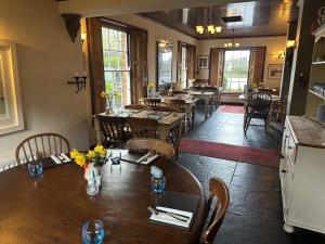 a dining room with tables and chairs in a restaurant at Badgers Inn in Petworth