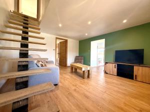a living room with a couch and a flat screen tv at Gîte d'Eléonore in Rupt-sur-Moselle