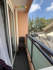 a chair sitting on the balcony of a house at Sparkle2600 at Megatower 1 in Baguio +2 photos