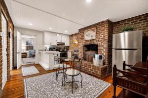 a kitchen and living room with a brick wall at Troup Square Manor Garden by Lucky Savannah in Savannah