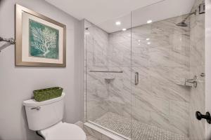 a bathroom with a shower and a toilet at Troup Square Manor Garden by Lucky Savannah in Savannah +16 photos