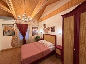 a bedroom with a bed and a chandelier at Hotel Commune 1889 in Kutaisi
