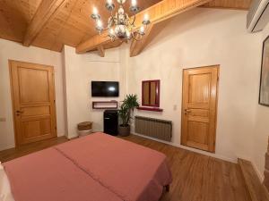 a bedroom with a bed and a chandelier at Hotel Commune 1889 in Kutaisi +19 photos
