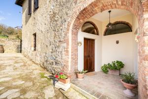 an entrance to a brick building with potted plants at Tipico casolare toscano Tenuta della Selva in Murlo +43 photos