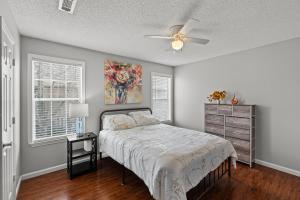 a bedroom with a bed and a ceiling fan at Spacious Corporate Condo - 2bd/2ba in Madison