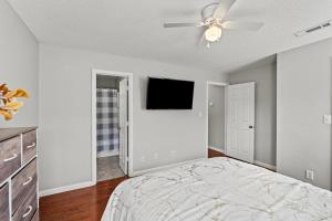a bedroom with a bed and a ceiling fan at Spacious Corporate Condo - 2bd/2ba in Madison