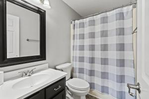 a bathroom with a sink and a toilet and a mirror at Spacious Corporate Condo - 2bd/2ba in Madison +11 photos