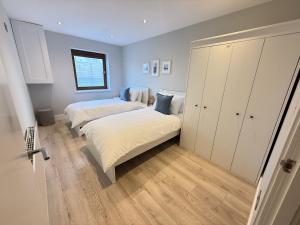 a bedroom with two beds and a closet at Coastal Charm in Dublin