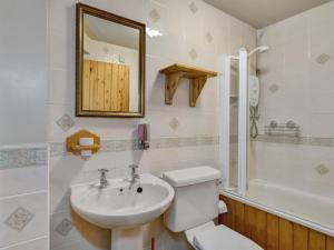 a bathroom with a sink and a toilet and a mirror at Luccombe- Ukc4919 in Timberscombe +15 photos