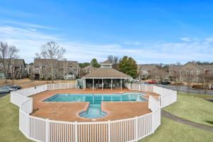 a swimming pool with a white fence around it at Spacious Corporate Condo - 2bd/2ba in Madison