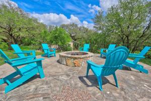 a group of blue chairs sitting around a fire pit at Arbor Creek in Wimberley