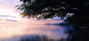 a view of a large body of water at sunset at Hostal Karina in San Ramón