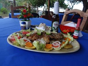 a plate of food on a table with a plate of food at Hostal Karina in San Ramón
