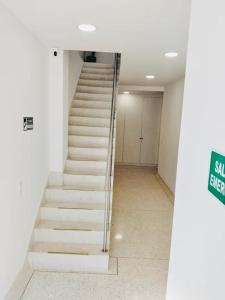 a stairway in a building with white steps at Apartahotel MONACO in Ginebra