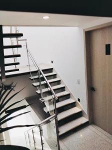 a spiral staircase in a room with a door at Apartahotel MONACO in Ginebra +1 photo