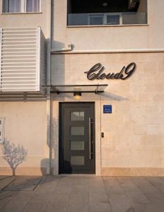 a doorway to a building with a sign over a door at Cloud9 Airport Suites in Močići