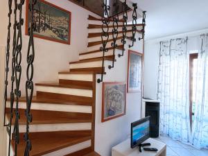 a staircase in a living room with a television at Casa Marlù - ArgonautiVacanze in Porto Azzurro