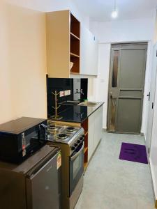 a kitchen with a stove and a stove top oven at Elevate Homes in Nairobi