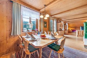 a dining room with a wooden table and chairs at Blaa Alm in Altaussee