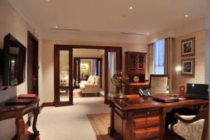 an office with a desk and a room with a couch at Polana Serena Hotel in Maputo