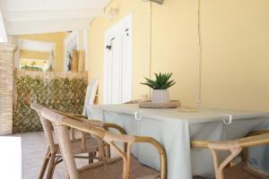 a dining room with a table and chairs at Pythari Summer House in Laganas