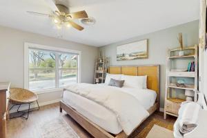 a bedroom with a bed with a ceiling fan and a window at R&R Acres in Aransas Pass