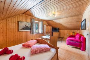 a room with a bed and a couch and a table at Blaa Alm in Altaussee