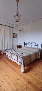 a bedroom with a large bed with a chandelier at Guest Art House Aurora in Pissignano