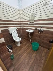a bathroom with a toilet and a sink at Hotel Sharda Palace in Deoghar