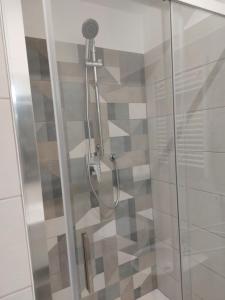 a shower with a glass door in a bathroom at Grazia Nest in Ciampino
