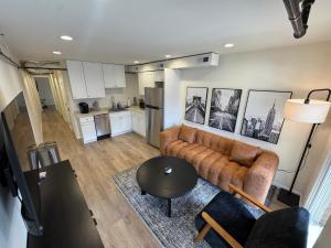 a living room with a couch and a table at The Brick & Beam 3rd Floor Apartment in St. Charles +16 photos