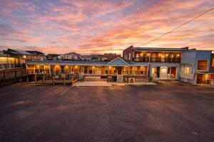 a building with a parking lot in front of it at The Brick & Beam 3rd Floor Apartment in St. Charles