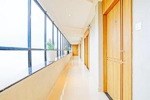 an empty corridor in a building with windows at Super Hotel O Raipur in Raipur