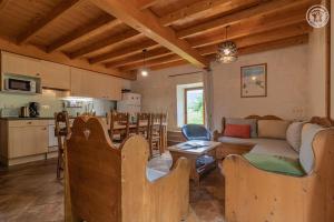 a kitchen and living room with a couch and a table at Gites le moulin - rochette in La Compôte