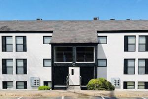 a large white house with a black door at The Avery in Atlanta